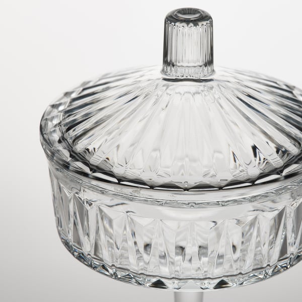 Clear glass container with intricate patterns. A fitted lid, adding elegance and functionality.