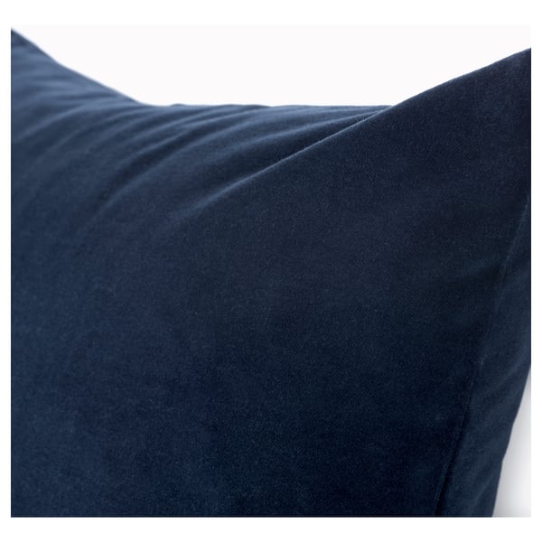 Close-up of a soft, luxurious blue velvet cushion. Smooth texture and elegant finish.