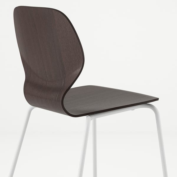 Dark wood chair with white metal legs, designed for comfort and support.