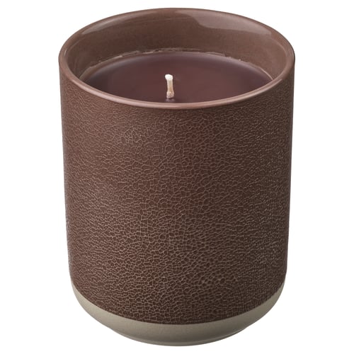 A SILKESTRÄD scented candle in a brown ceramic container with a leather-like texture. The candle has a single wick and is unlit.