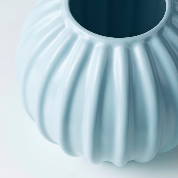 Light blue glazed stoneware vase with smooth, fluted design.