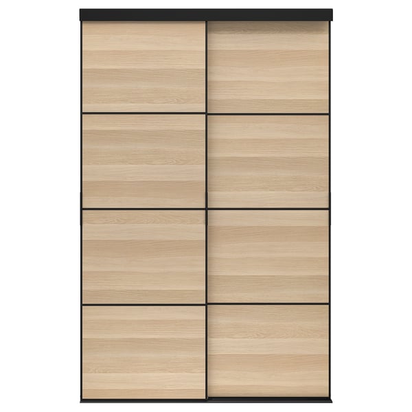 The SKYTTA wardrobe with light oak and black sliding doors featuring six panels.