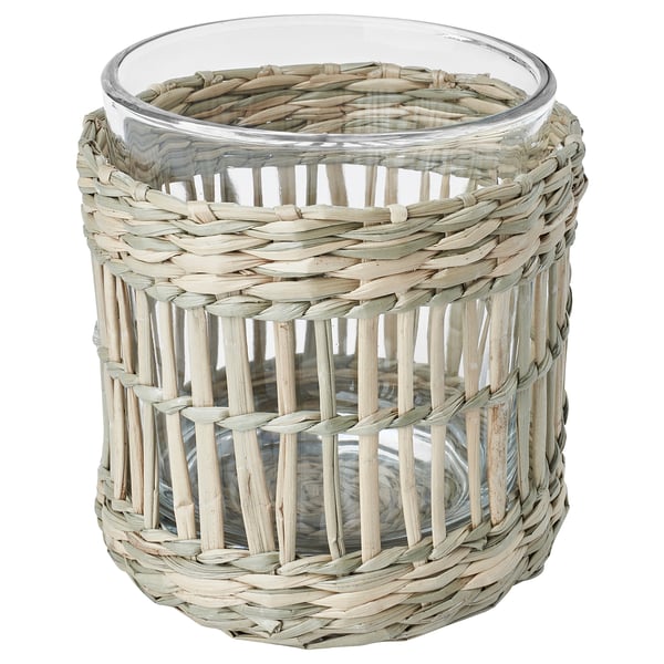 A SLIPPRIG tealight holder, round, beige with wicker design. Its made of sedge and glass.