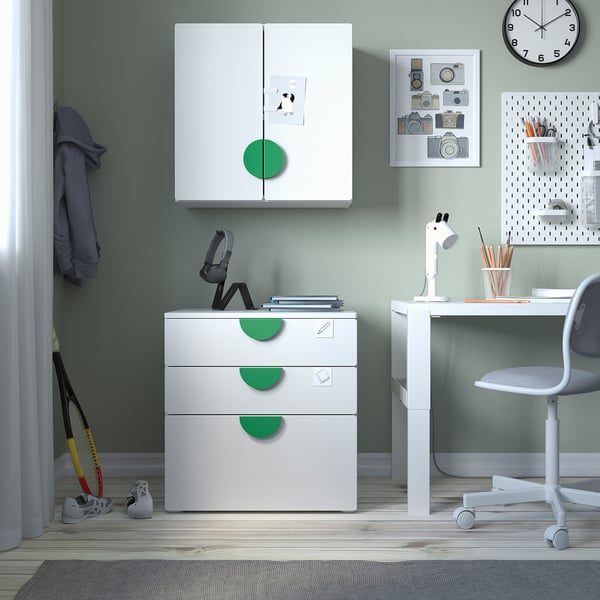 Childrens room with white & green SMÅSTAD furniture, cabinet, desk, chair, clock, and toy.
