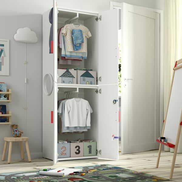 Kids white closet with clothes hangers, shelves, and storage boxes.