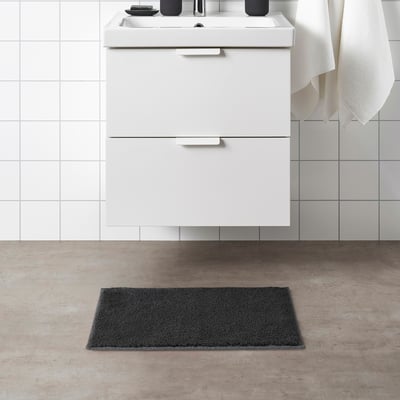 Modern bathroom SÖDERSJÖN grey bath mat, white cabinet, and sink.