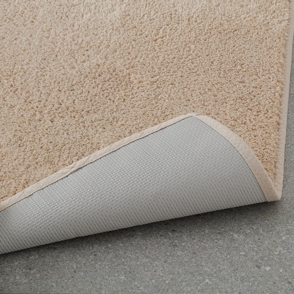 Bath mat with thick cotton pile and latex backing for comfort and grip.