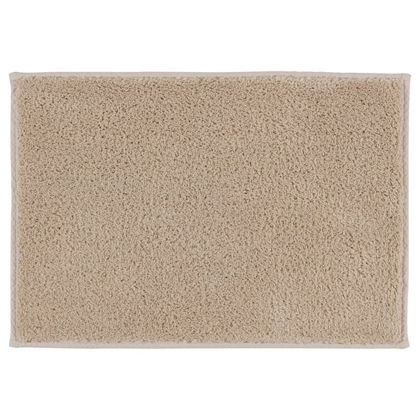 SÖDERSJÖN bath mat, beige. Soft cotton, latex backing, rectangular with textured surface.