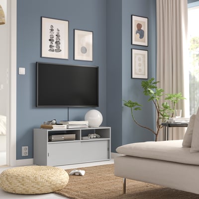 Modern living room with blue walls, white SPIKSMED tv stand, functional furniture, and decor.