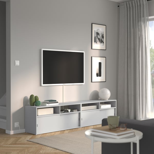 Modern living room with SPIKSMED tv bench, flat-screen tv, and decor.