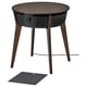 A dark brown, round STARKVIND air purifier table with wooden legs and a control panel, accompanied by a black square philtre.