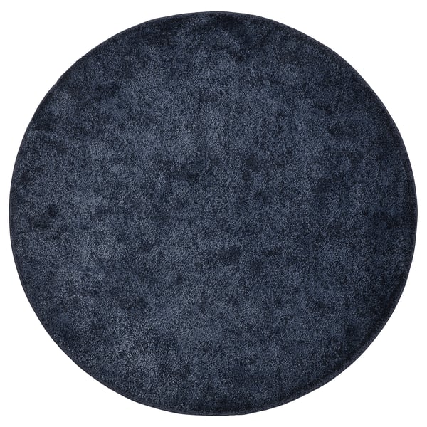 Circular navy blue STOENSE rug, soft thick pile, uniform design.