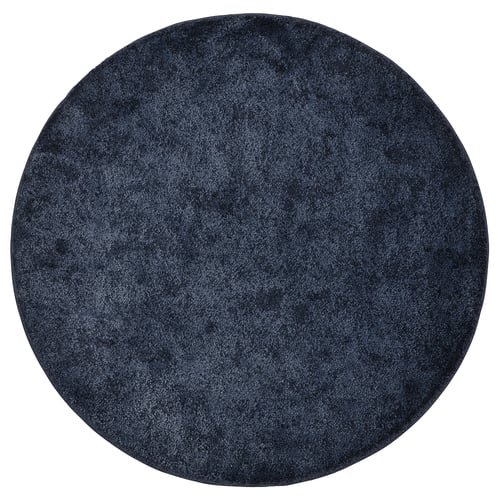 Circular navy blue STOENSE rug, soft thick pile, uniform design.
