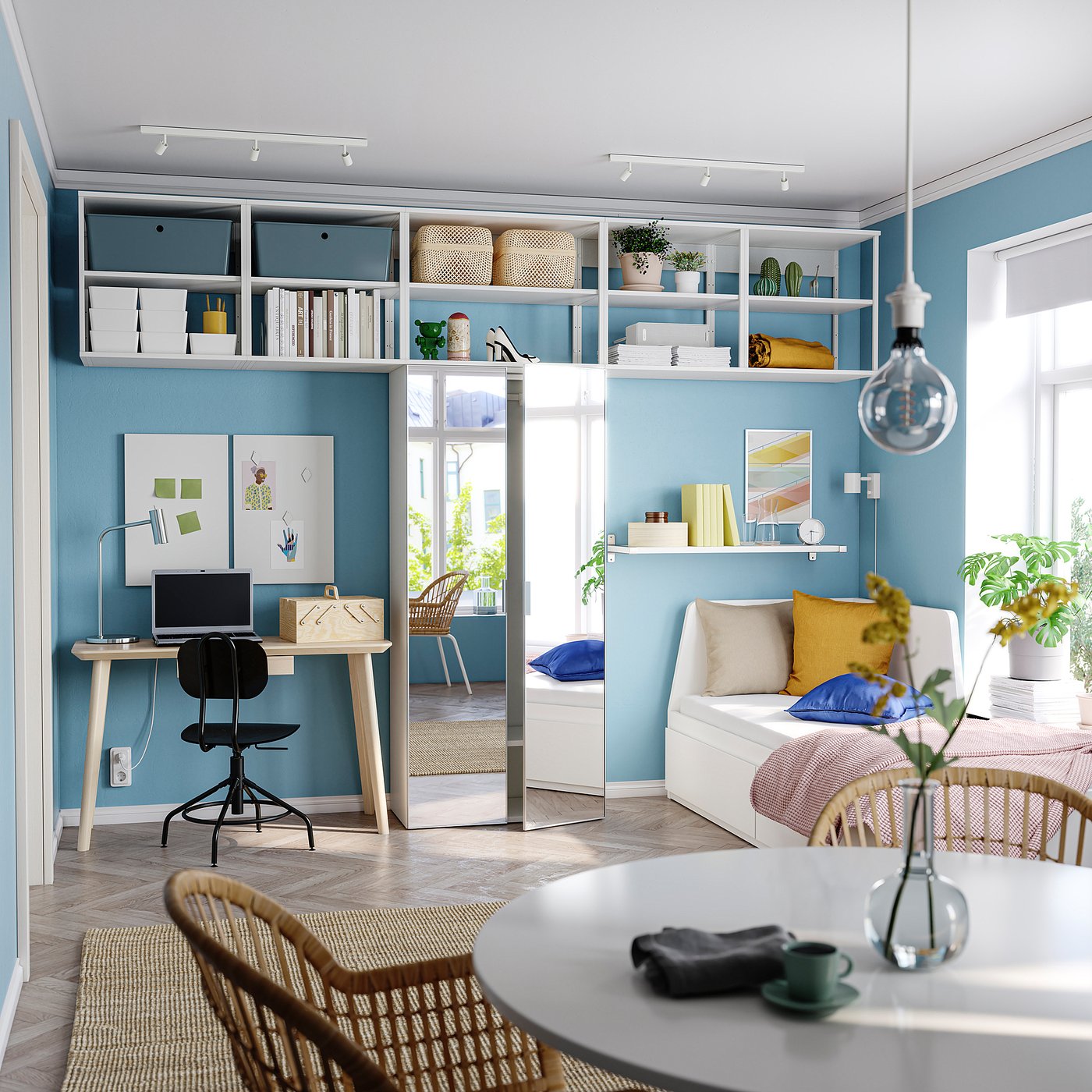 Modern blue room with white furniture, wooden desk, black chair, white shelves, and large mirror door.