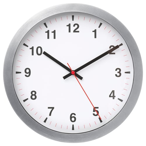 A round, silver-framed wall clock with a white face, black numbers, and hands, indicating the time.