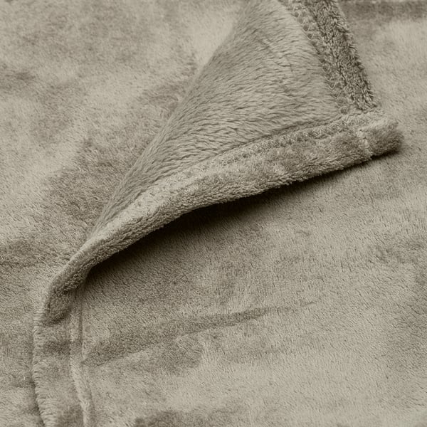 Close-up of soft, plush fleece bedspread, showcasing its smooth texture and comfortable feel.