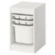 A white TROFAST storage unit with plastic drawers and a bin. Its designed for organising kids items.