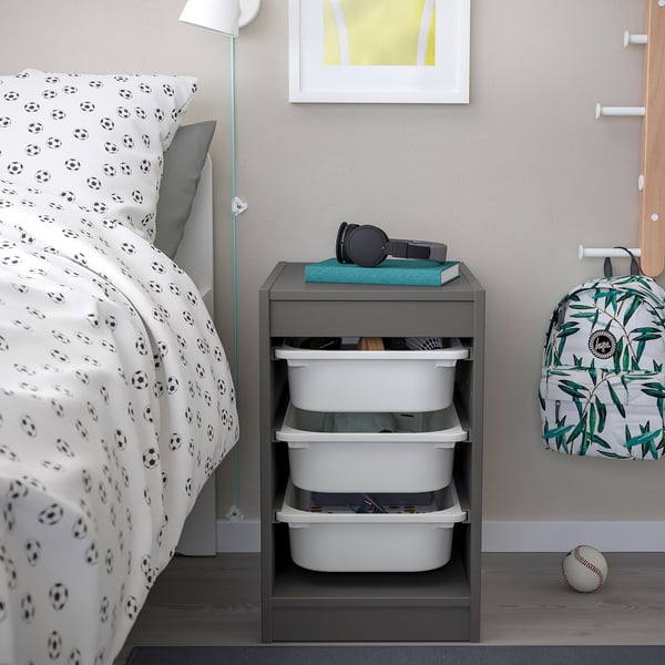 TROFAST grey storage with drawers, football bedding, and kids items.