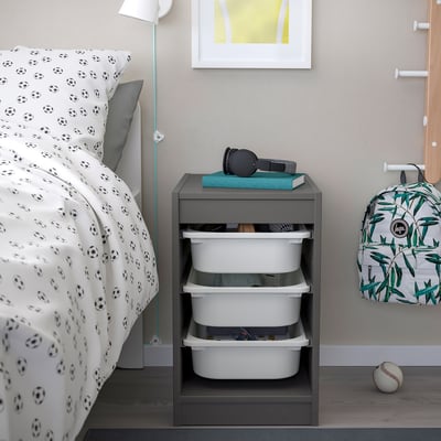 TROFAST grey storage with drawers, football bedding, and kids items.