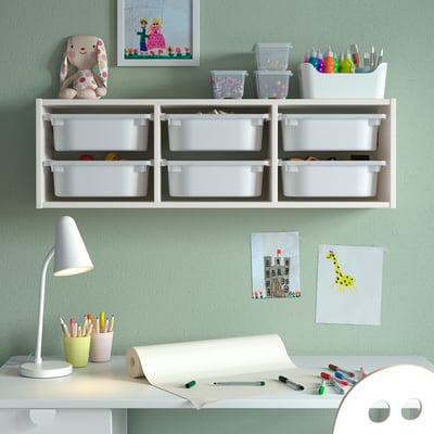 White TROFAST wall storage with plastic boxes, used for toy storage and organisation in a kids room.