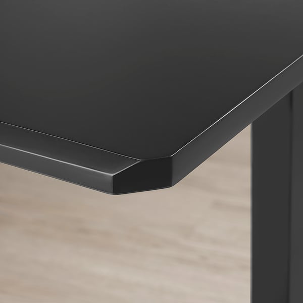 Modern black tabletop with sleek edges, part of the UPPSPEL series, showcasing durability and smooth finish.