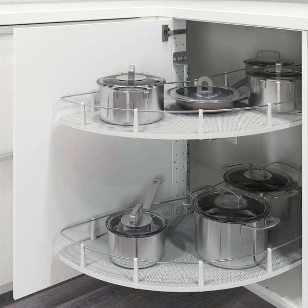 Kitchen corner cabinet with pull-out shelves holding pots and pans, maximises storage space and accessibility.