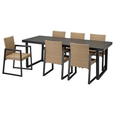 Modern outdoor dining set VÄRMANSÖ with dark grey table and beige wicker chairs.