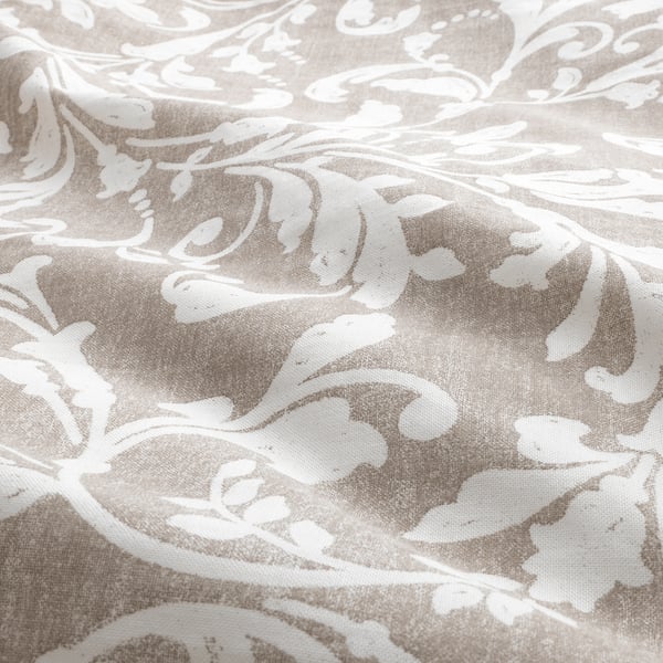 Floral quilt coverup, soft cotton texture, light beige with intricate white patterns.