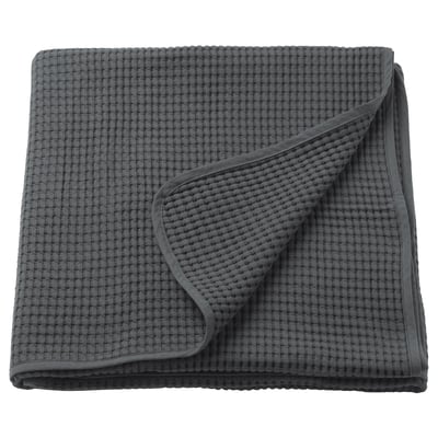 A folded grey VÅRELD bedspread in a textured weave, made of 100% cotton.