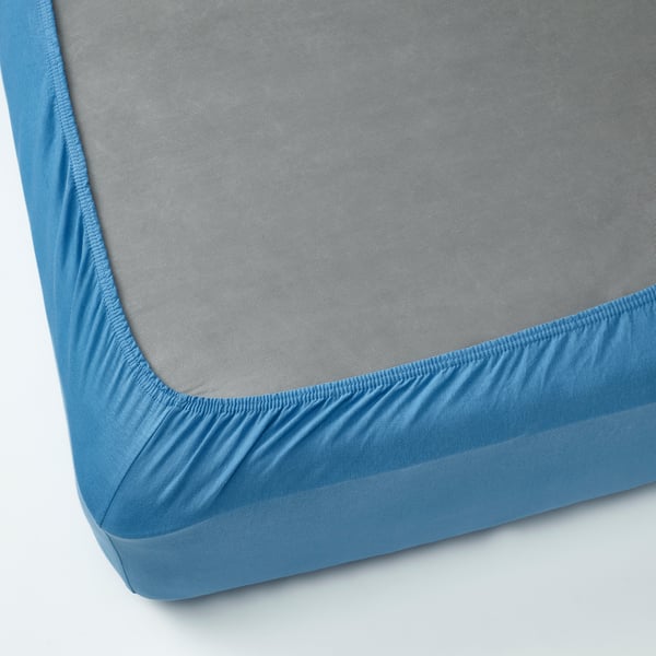 Blue cotton jersey fitted bed sheet with elastic corners.