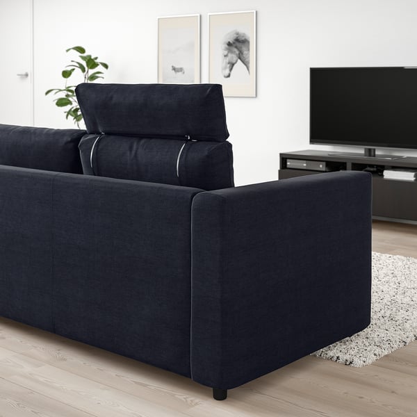 Modern living room with large black VIMLE sofa, tv, and plant.