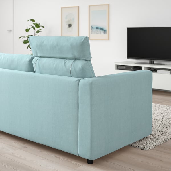 Light blue VIMLE sofa in modern living room with minimalist decor, positioned between a tv and wall art.