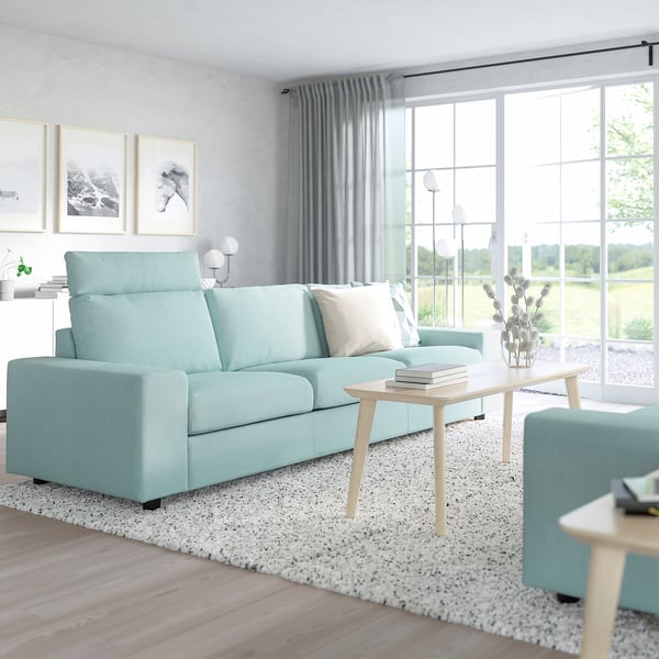 Modern blue VIMLE sofa in minimalist living room with large windows and subtle decor.