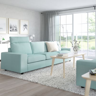 Modern blue VIMLE sofa in minimalist living room with large windows and subtle decor.