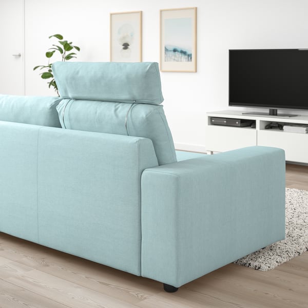 Light blue VIMLE sofa in modern living room with tv unit and plant. Comfortable, sleek design.