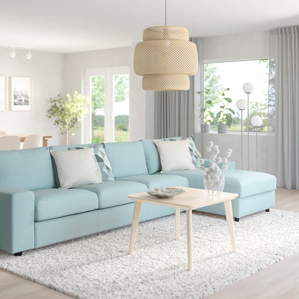 Blue VIMLE sectional sofa, low coffee table, and large pendant light with light wood and white decor.