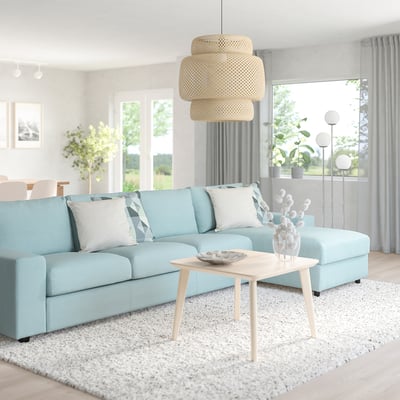 Blue VIMLE sectional sofa, low coffee table, and large pendant light with light wood and white decor.