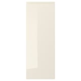 A high-gloss beige VOXTORP cabinet door with integrated handles, smooth and modern.