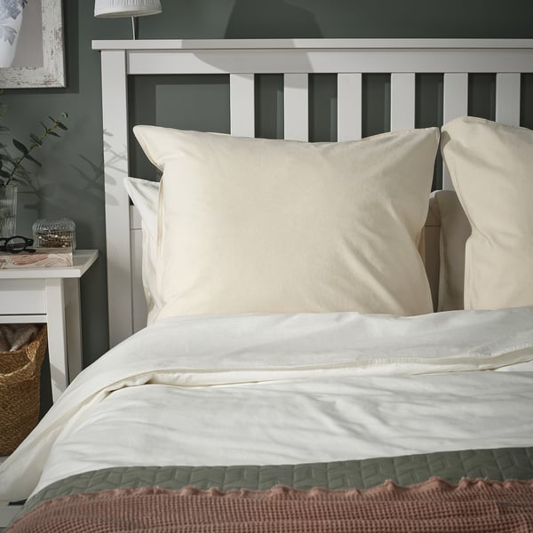 ÄNGSLILJA white bedding set. Crisp white linen on large bed, cream pillows. Soft, breathable cotton. Grey and pink accents.