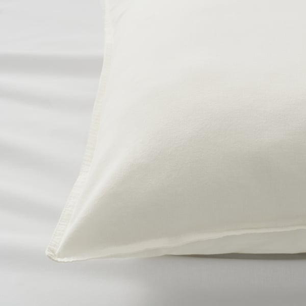 Close-up of a white pillowcase with neat stitching, showcasing soft, high-quality cotton fabric.