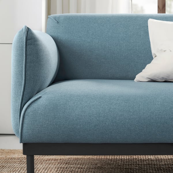 Blue upholstered modern sofa with sleek legs and plush pillow. Comfortable and stylish.
