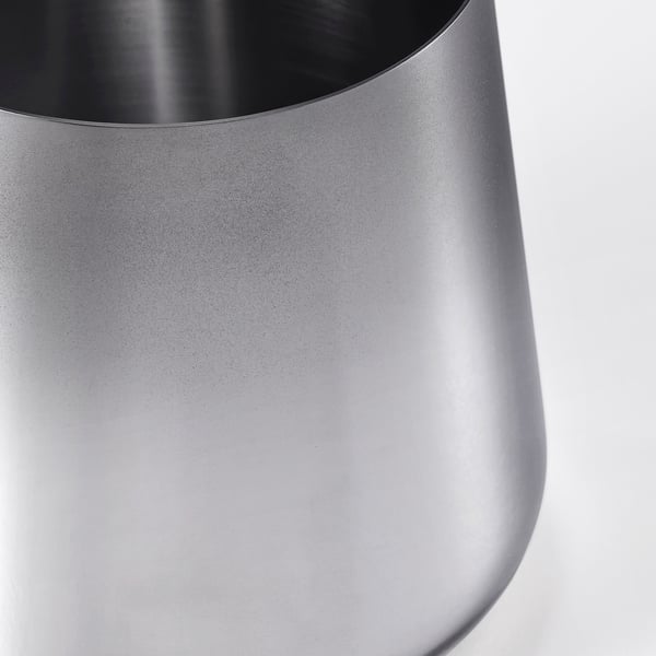 Sleek, stainless-steel jar with smooth surface, reflecting light, showcasing durability and modern design.