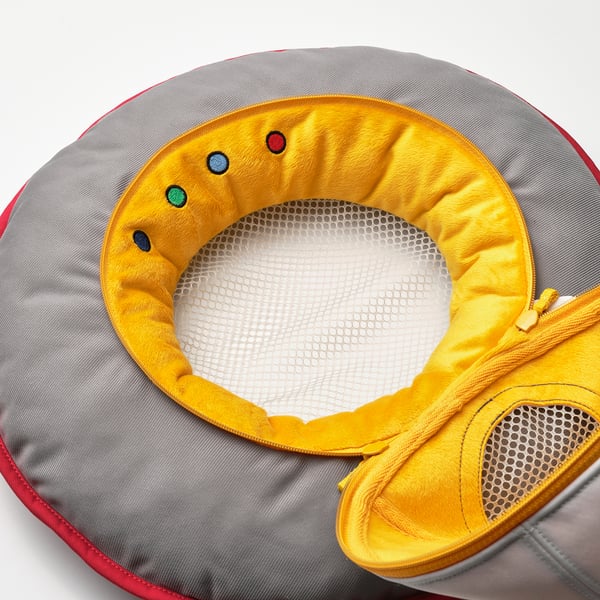 Spaceship toy with zip, mesh centre, soft yellow lining, multi-colored dots; recycled materials.
