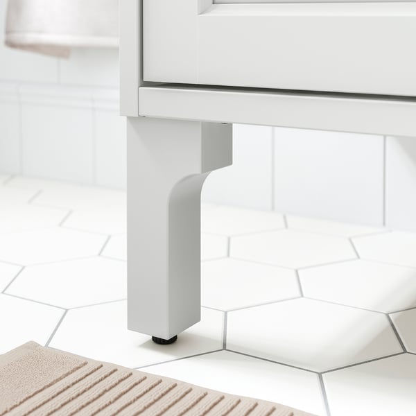 Modern bathroom cabinet with sturdy, adjustable wooden leg for stability.