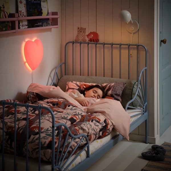 Childs bedroom with blue bed, red panda duvet, lamp, & toys.
