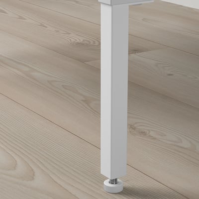 Close-up of AURDAL table leg; sleek white finish, sturdy construction, height adjustment detail.