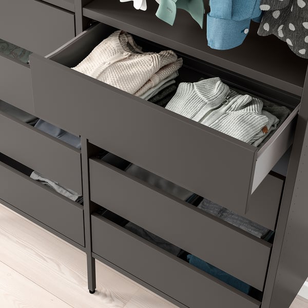 Open AURDAL drawer showing neatly folded clothes, demonstrating storage versatility.