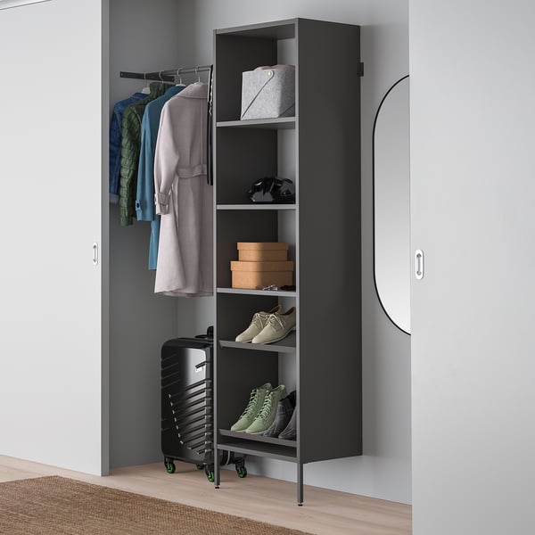 Black AURDAL closet storage with shelves and hanging space, fitting between doors.
