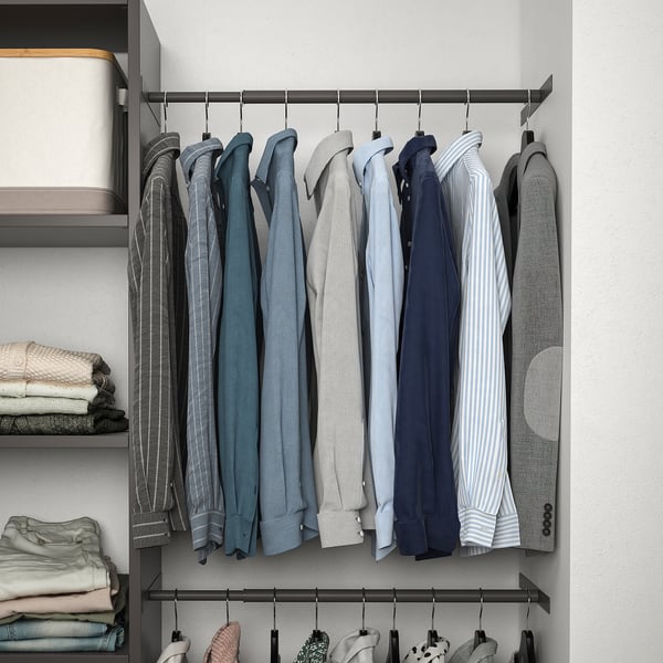 Closet with hanging shirts, pants, and folded clothes on shelves. Includes adjustable feet and shelves.