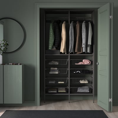 Modern black AURDAL storage unit with green walls, adjustable shelves, drawers, and a large mirror for minimalist design.